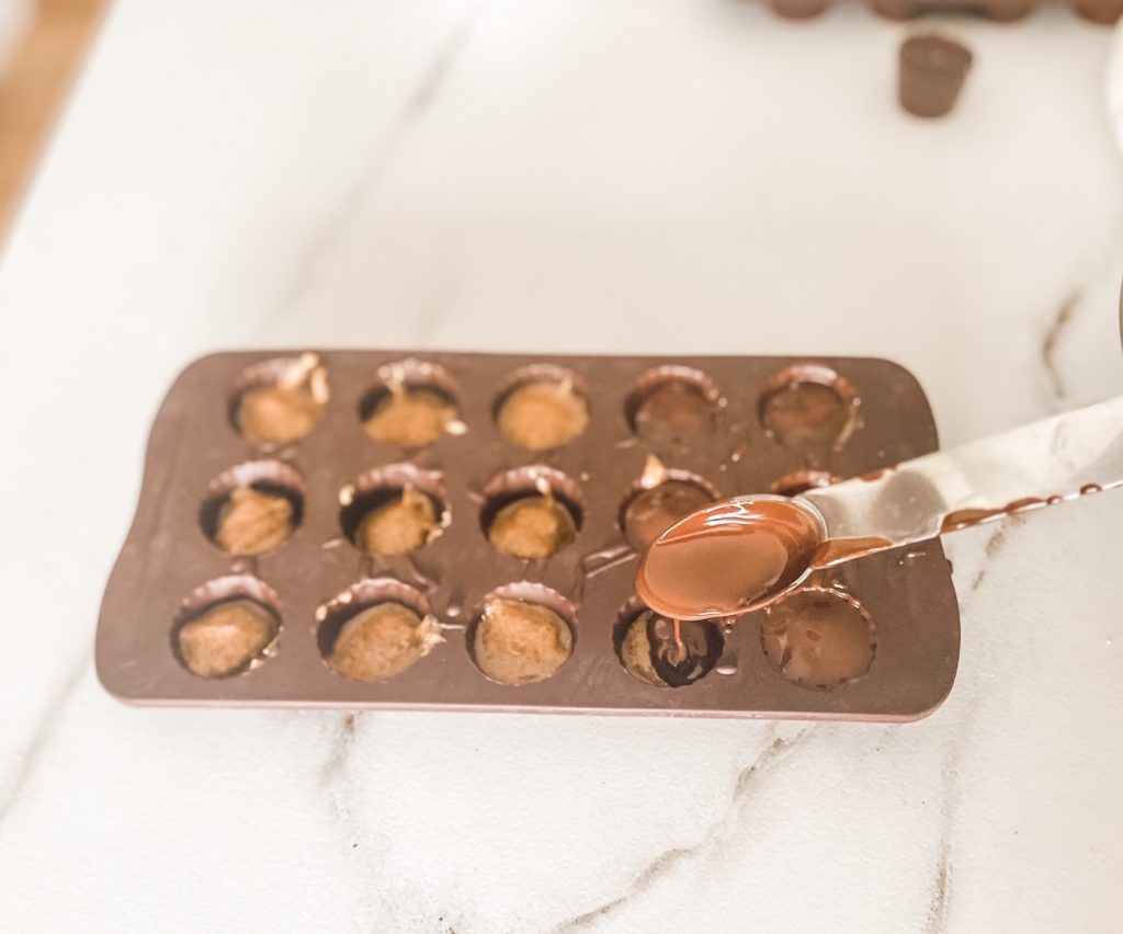 melted chocolate poured for almond butter cups