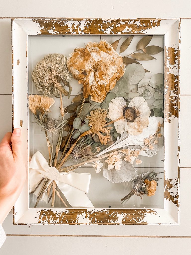 Pressed wedding bouquet in rustic frame