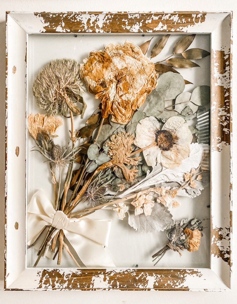 Pressed and dried wedding bouquet in frame