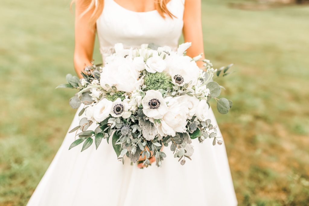 Bride holding fresh wedding bouquet