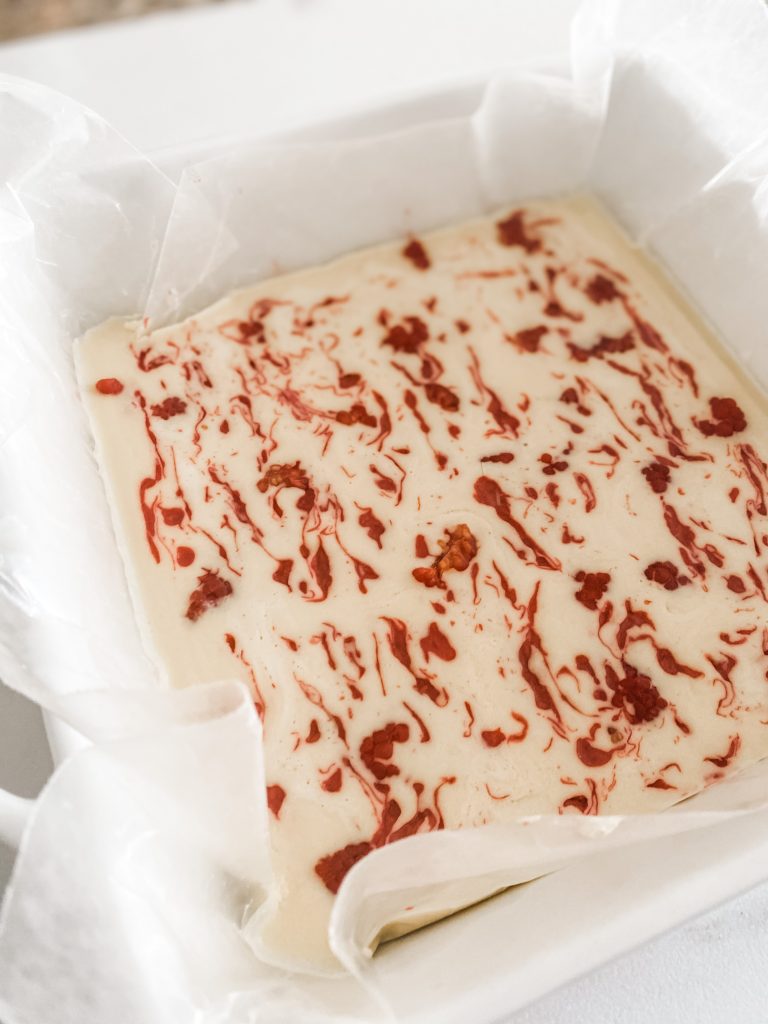 ceramic pan with raspberry bark inside with red swirls before breaking it into pieces