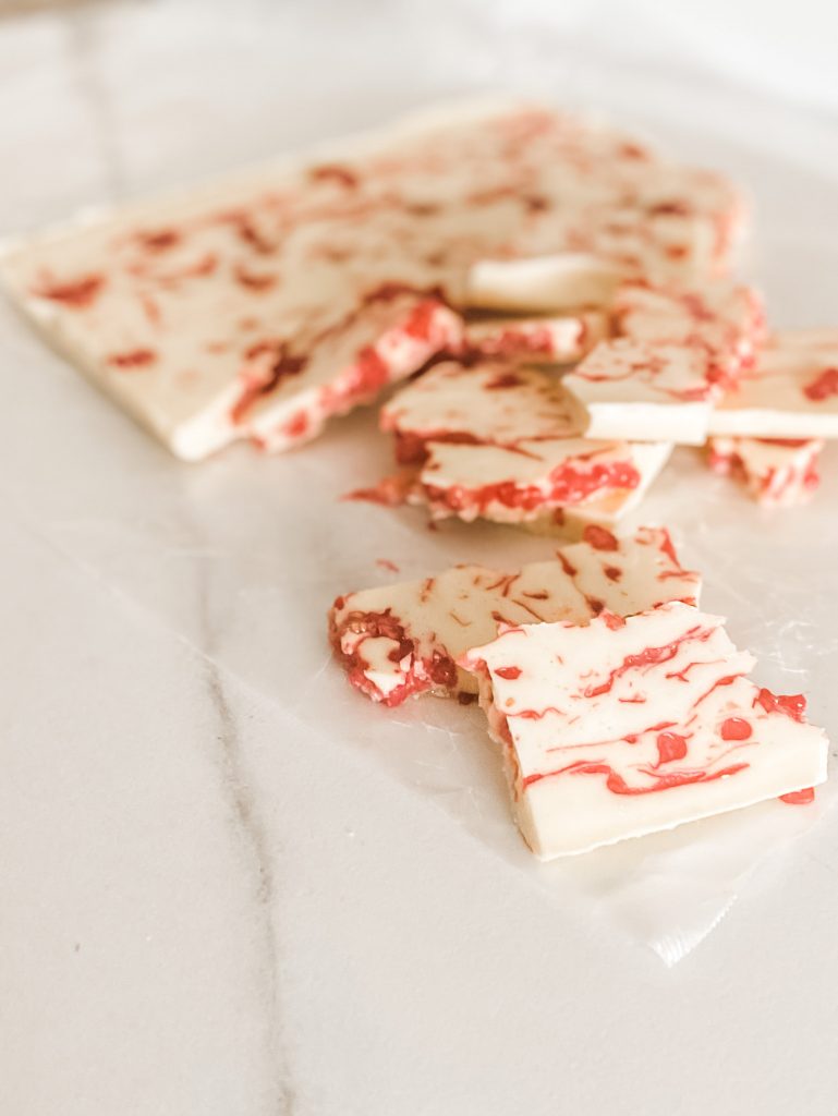 broken pieces of fresh raspberry almond bark refined sugar free and dairy free