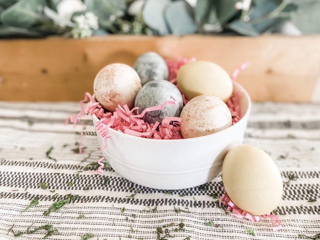 Naturally dyed Easter eggs in white bowl with pick crinkle paper bloombeautifullyco