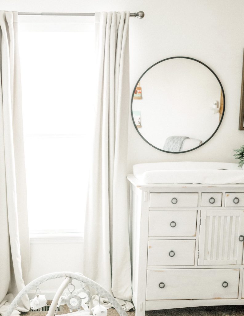 window and side of chalk painted dresser with mirror above