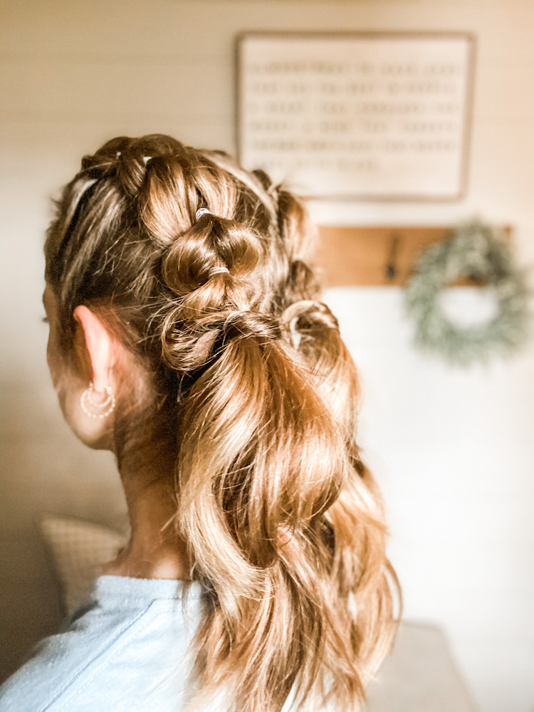 bubble braid pigtails shown from the back corner view on dark blonde hair