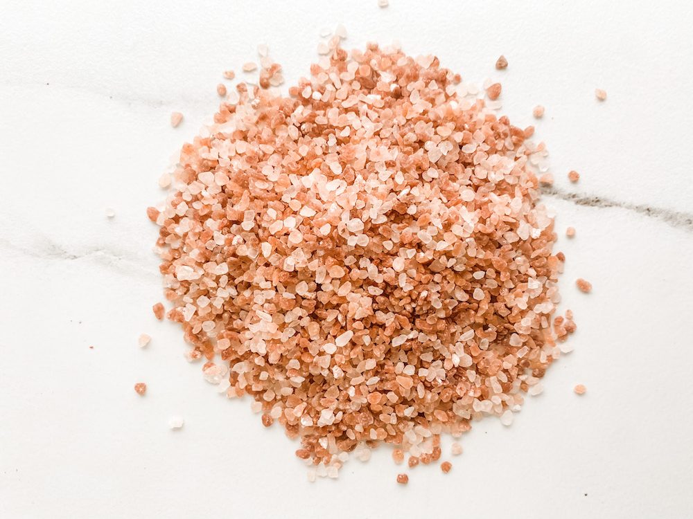 pile of pink Himalayan salt on marble surface