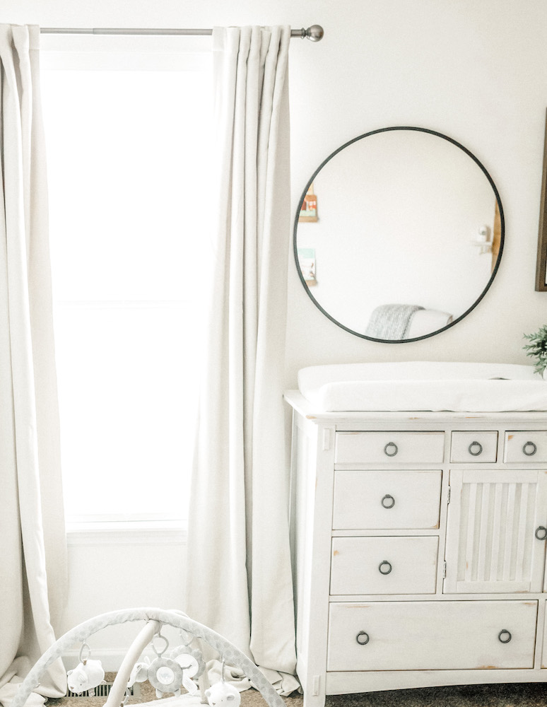 light linen window treatments curtains next to white dresser and round mirror